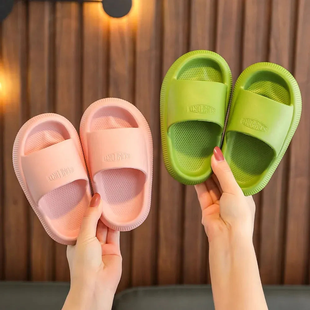 Children's non-slip EVA slippers in bright colours, showing the 1.5cm thick sole.
