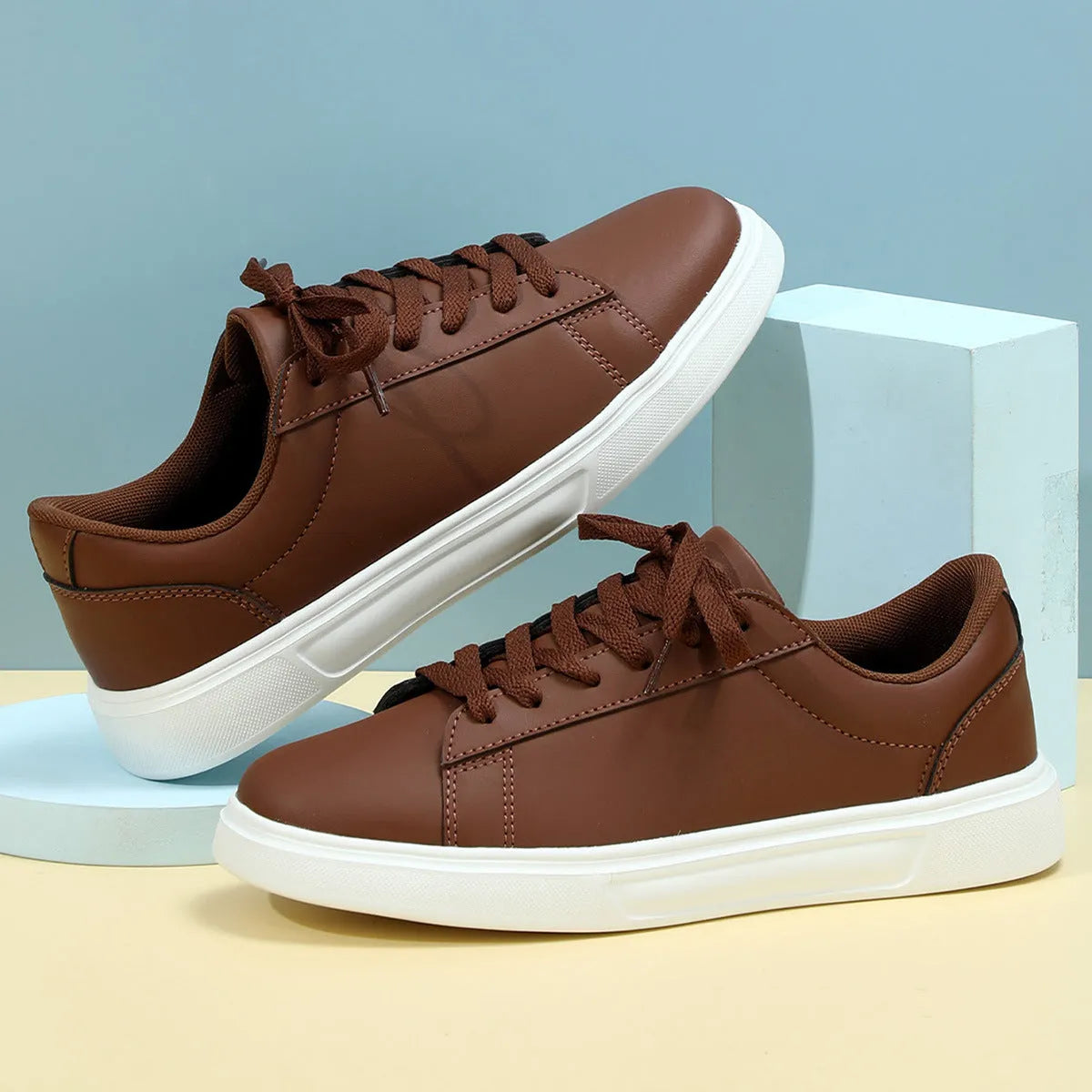 Low-top platform skate shoes with cross-strap detail and mid-heel design in beige brown colour