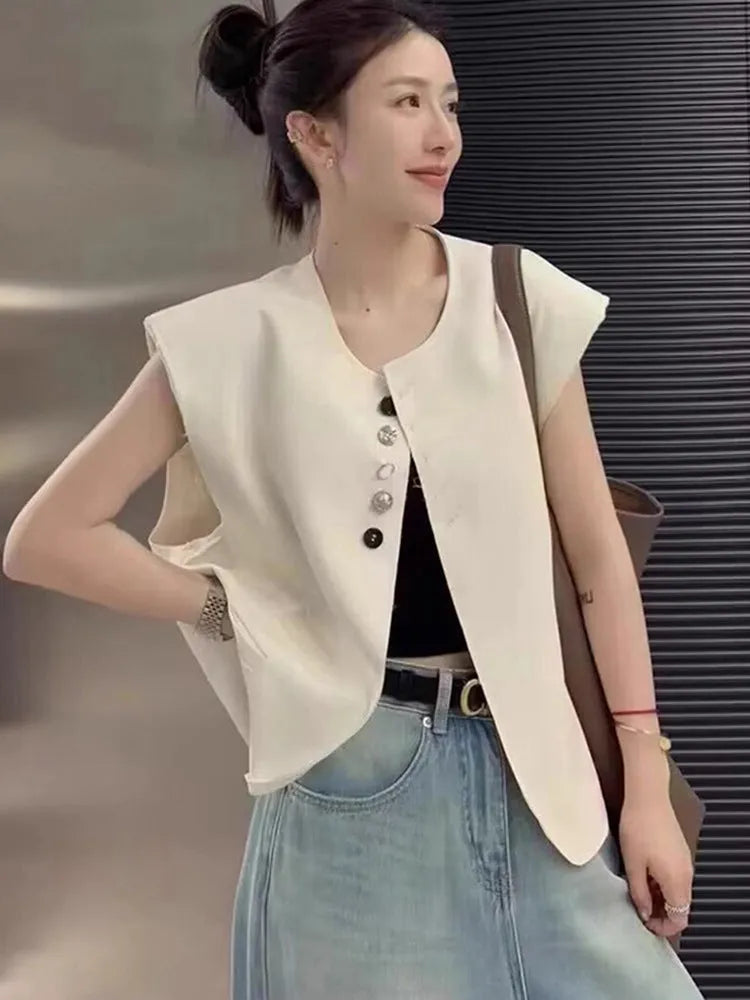 Women's loose fit polyester vest in milky white and black colours with pocket details.