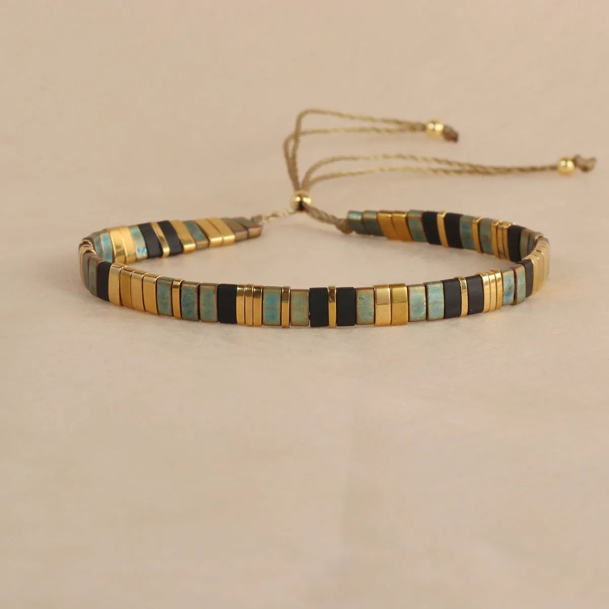 Geometric beaded pull-on bracelet in milky white, black, green, blue, or red colours