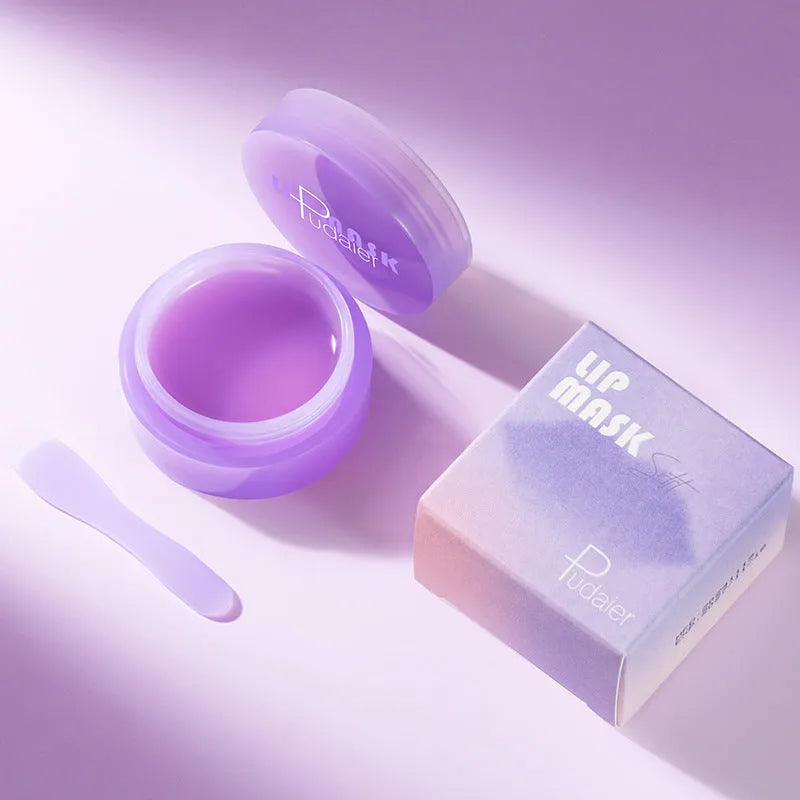 Box containing a lip balm pot, exfoliating lip film, and a plastic scraper tool for lip care.