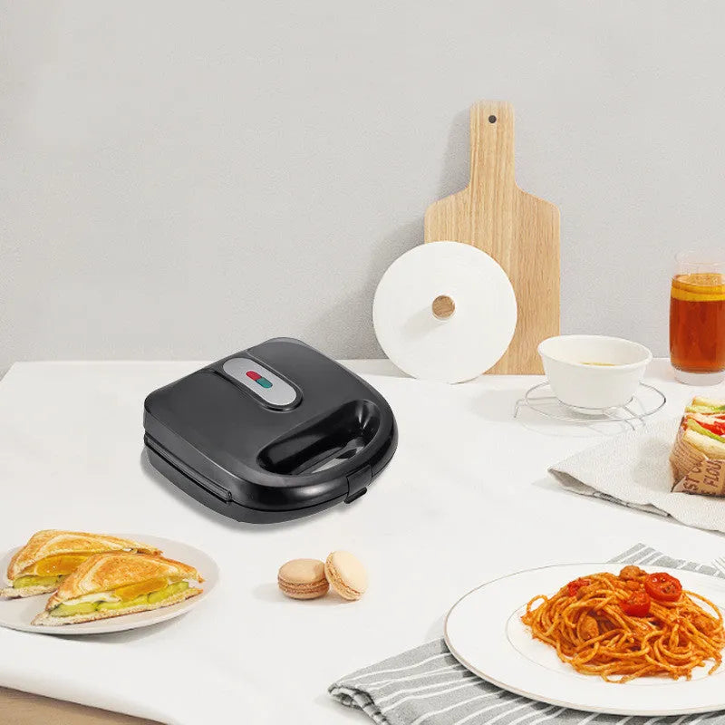 Black electric sandwich pan with double-sided heating, exchangeable plates, and brushed stainless steel cover