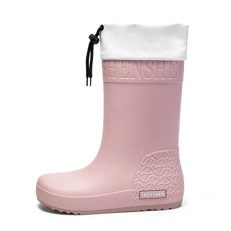 Women's solid colour PVC rain boots with non-slip sole in apricot, black, brown, or pink.