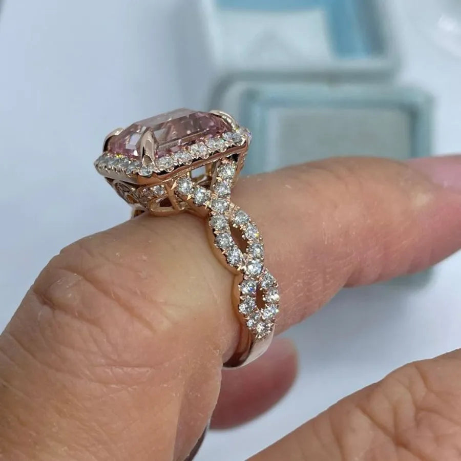 Rose gold electroplated alloy ring with geometrical design shown on hand