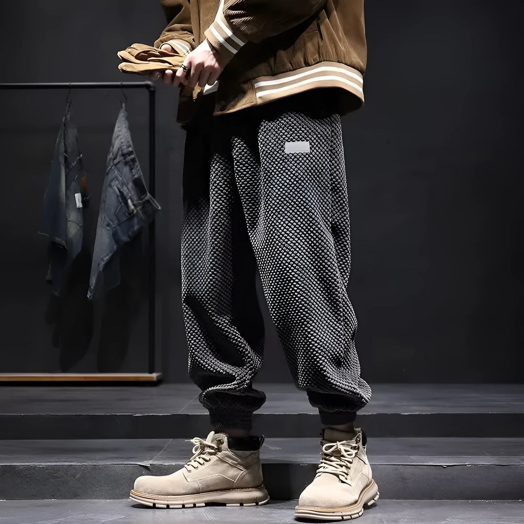 Men's grey ankle-tied casual sweatpants with a light straight leg on a neutral background.