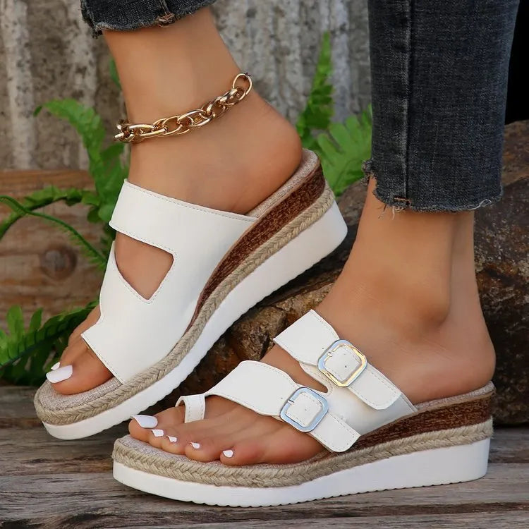 White patent leather women's sandals with wedge heel and woven finger-fit straps in peep toe design