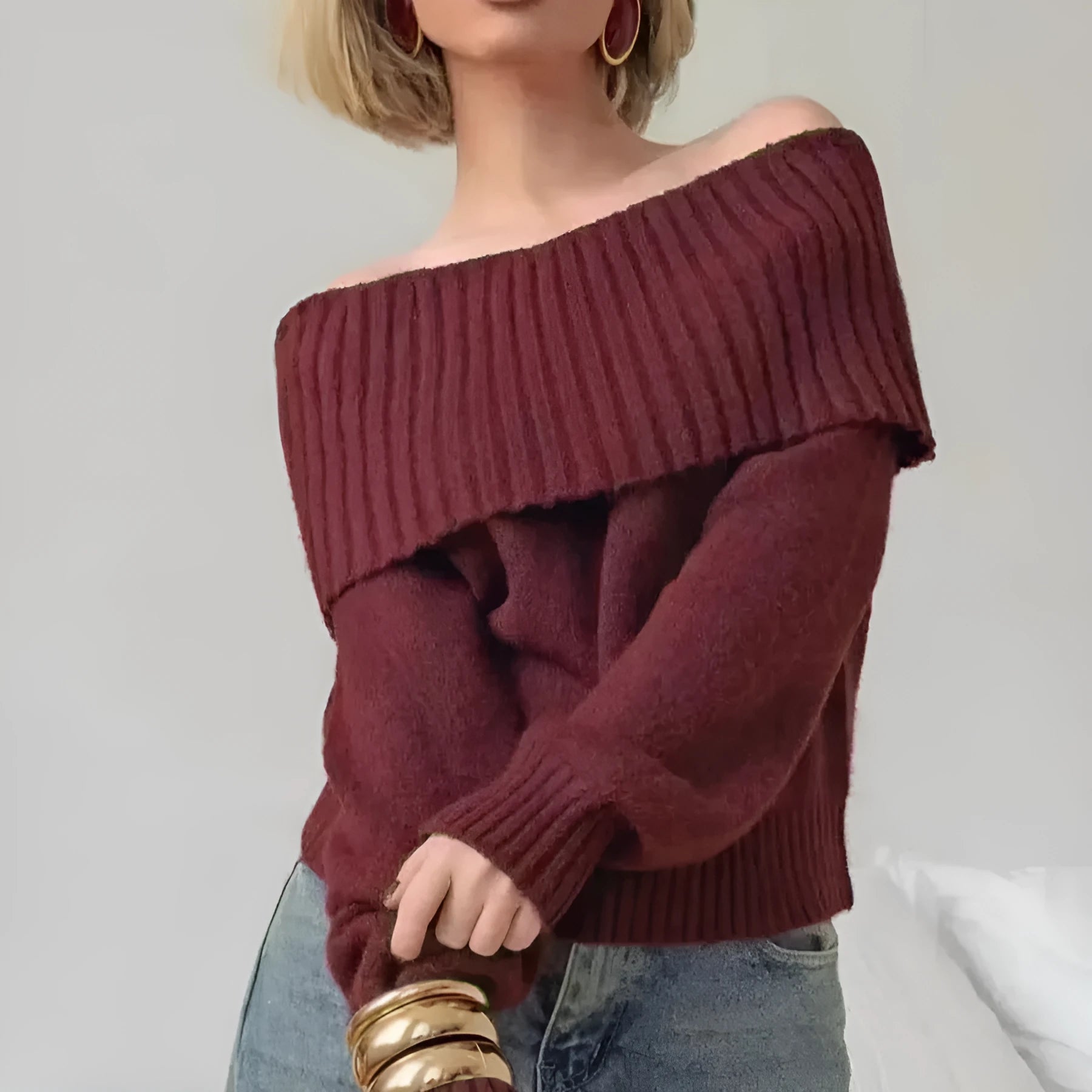 Grey off-the-shoulder sweater with a 3D pattern and strapless design, laid flat.