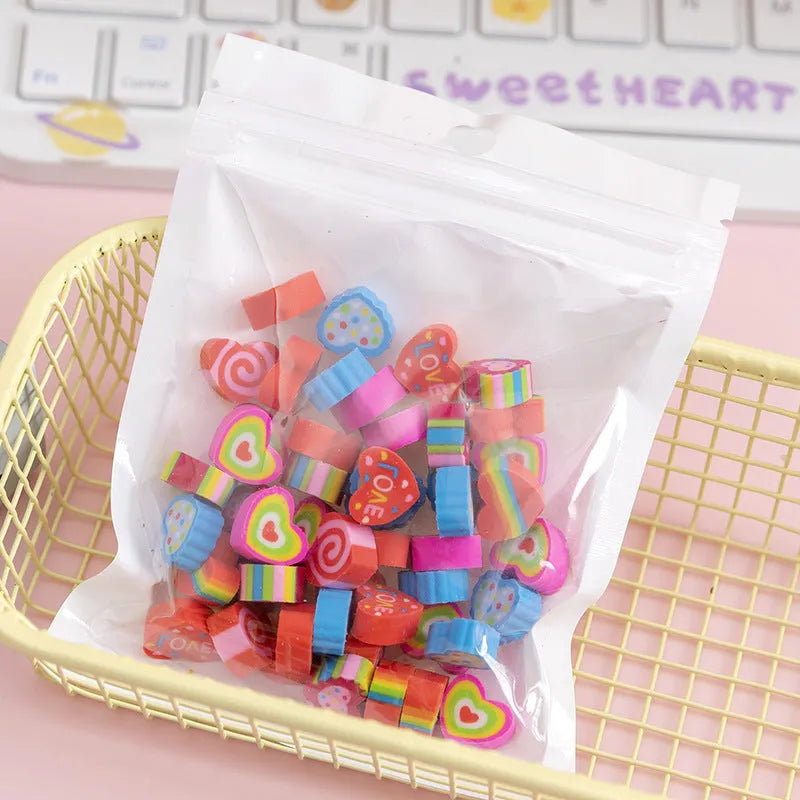 50 colourful cartoon mini erasers in pearlescent bags showing fruit, animal, and holiday designs