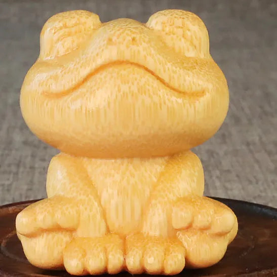Small smiling frog ornament carved from solid bamboo measuring 5cm in height