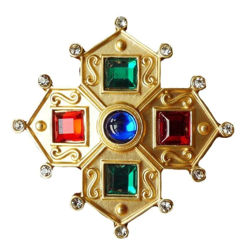 A vintage-style baroque brooch made of zinc alloy in a diamond shape on a fabric background.
