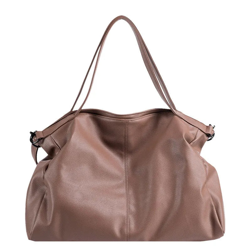 Large soft black PU messenger bag with car suture detail, shown with zip open revealing organiser pockets.
