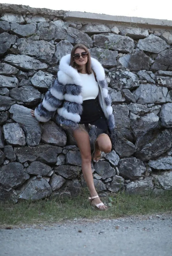 A woman's loose-fitting artificial fur hooded coat in street fashion style.