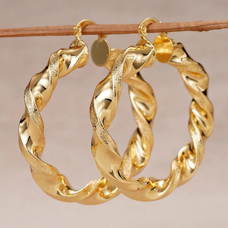 Women's geometric drop earrings with clip-on fastening in copper with ring and line design elements