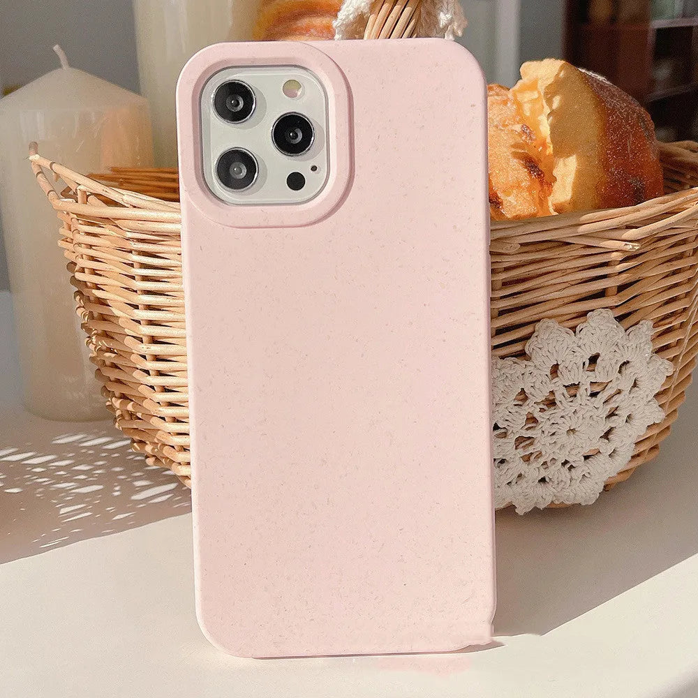 Fully degradable wheat straw bioplastic rear cover case for Apple iPhone on a table, shown in one of seven available colours.
