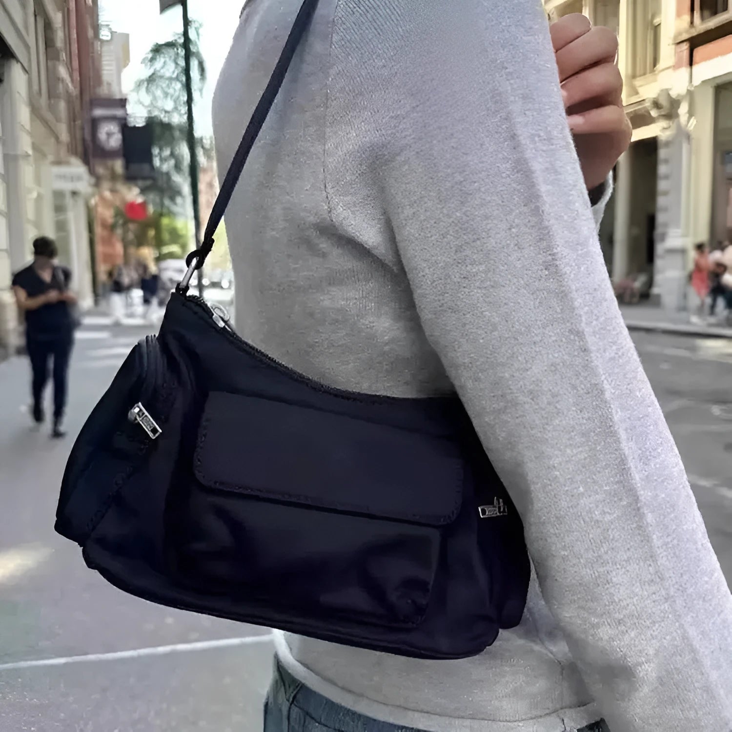 Simple black lightweight PU women's shoulder bag with double pockets and side line detail.