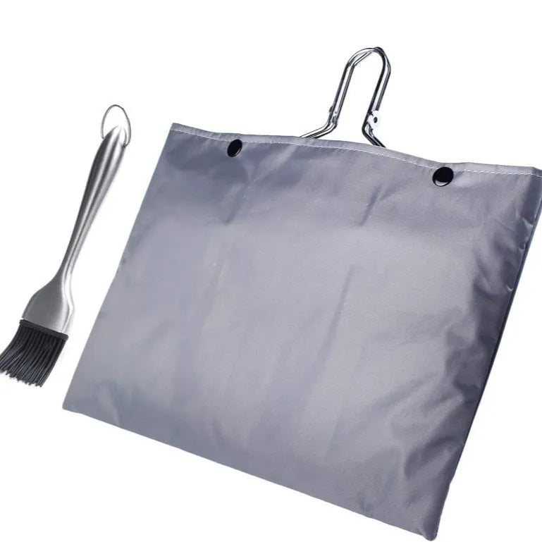 Square stainless steel folding barbecue mesh basket with a cleaning brush on a grill.