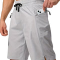 Man wearing solid grey quick-drying polyester beach shorts with a straight leg design.