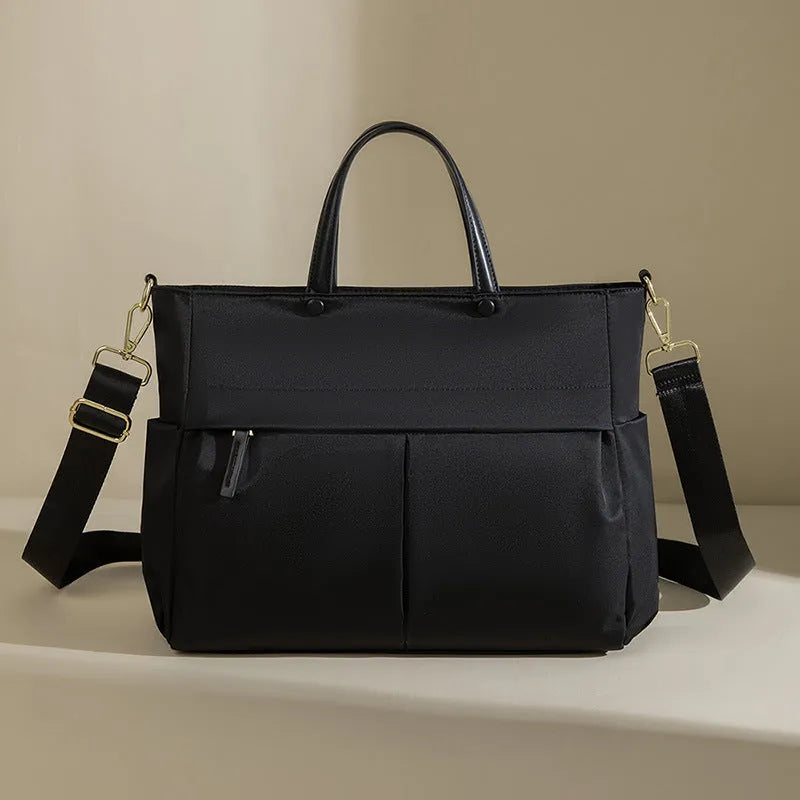 Portable oxford cloth laptop briefcase for women in elegant black with contrast stitching and large capacity.