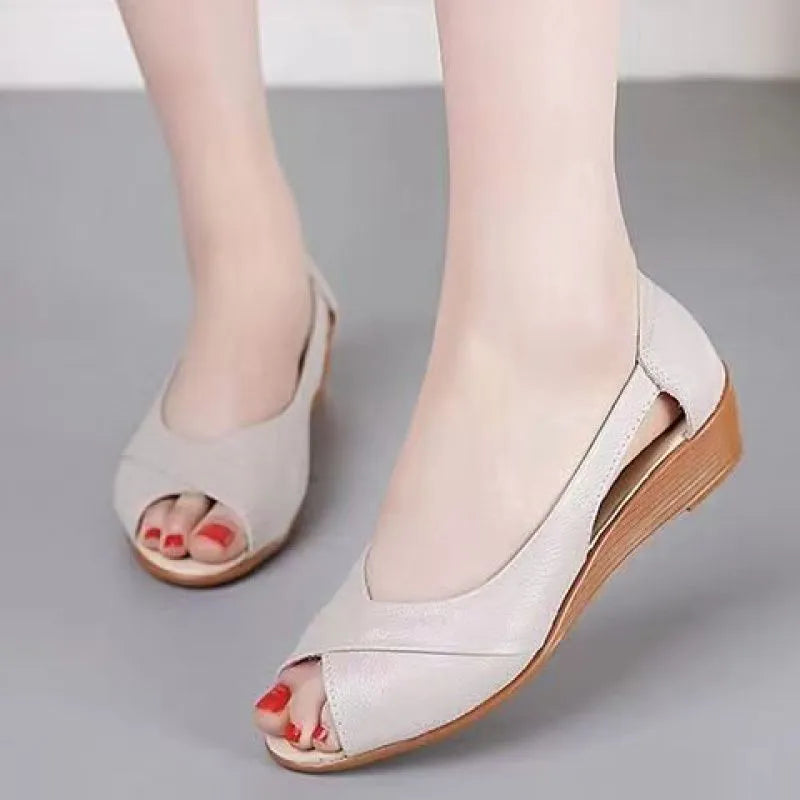 Women's black peep toe sandals with an ankle buckle and a rubber mid heel on a white background.