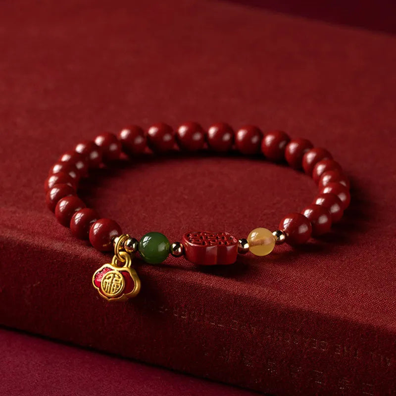 Cinnabar bracelet with raw emperor sandstone beads and a fu character charm in new Chinese style.