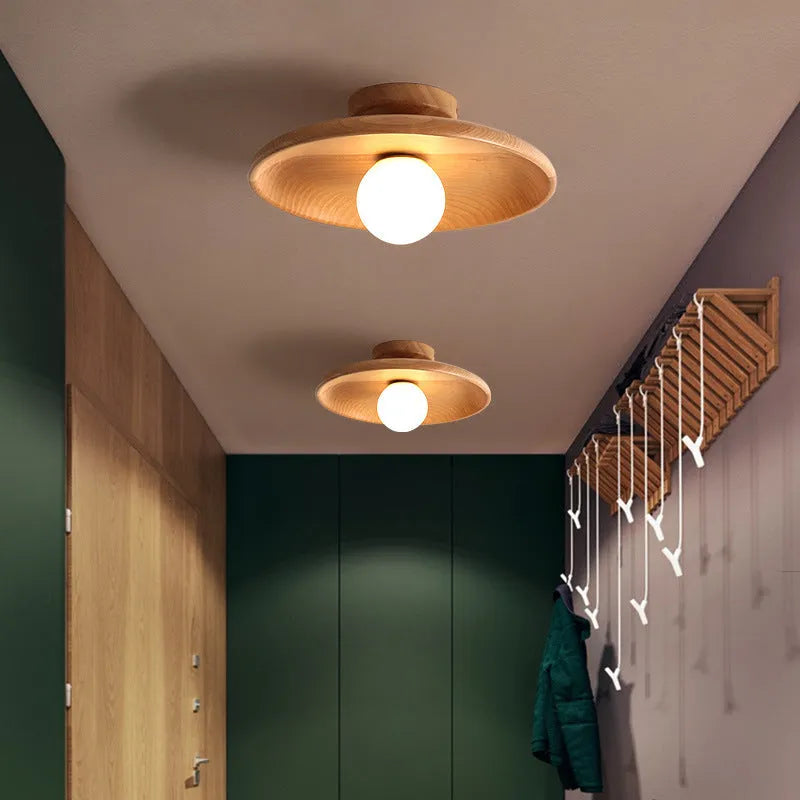 Minimalist solid wood and glass ceiling lamp in natural wood finish, 28cm diameter.