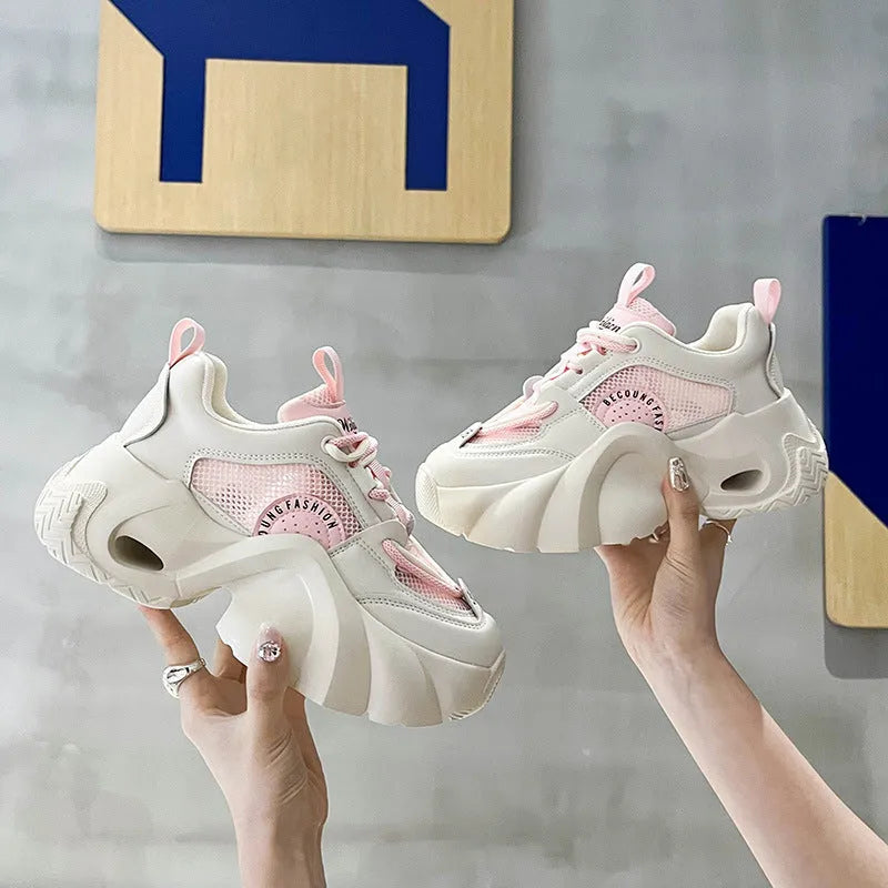 Women's casual sneakers in beige with thick sole, cross shoulder straps, and mesh lining.
