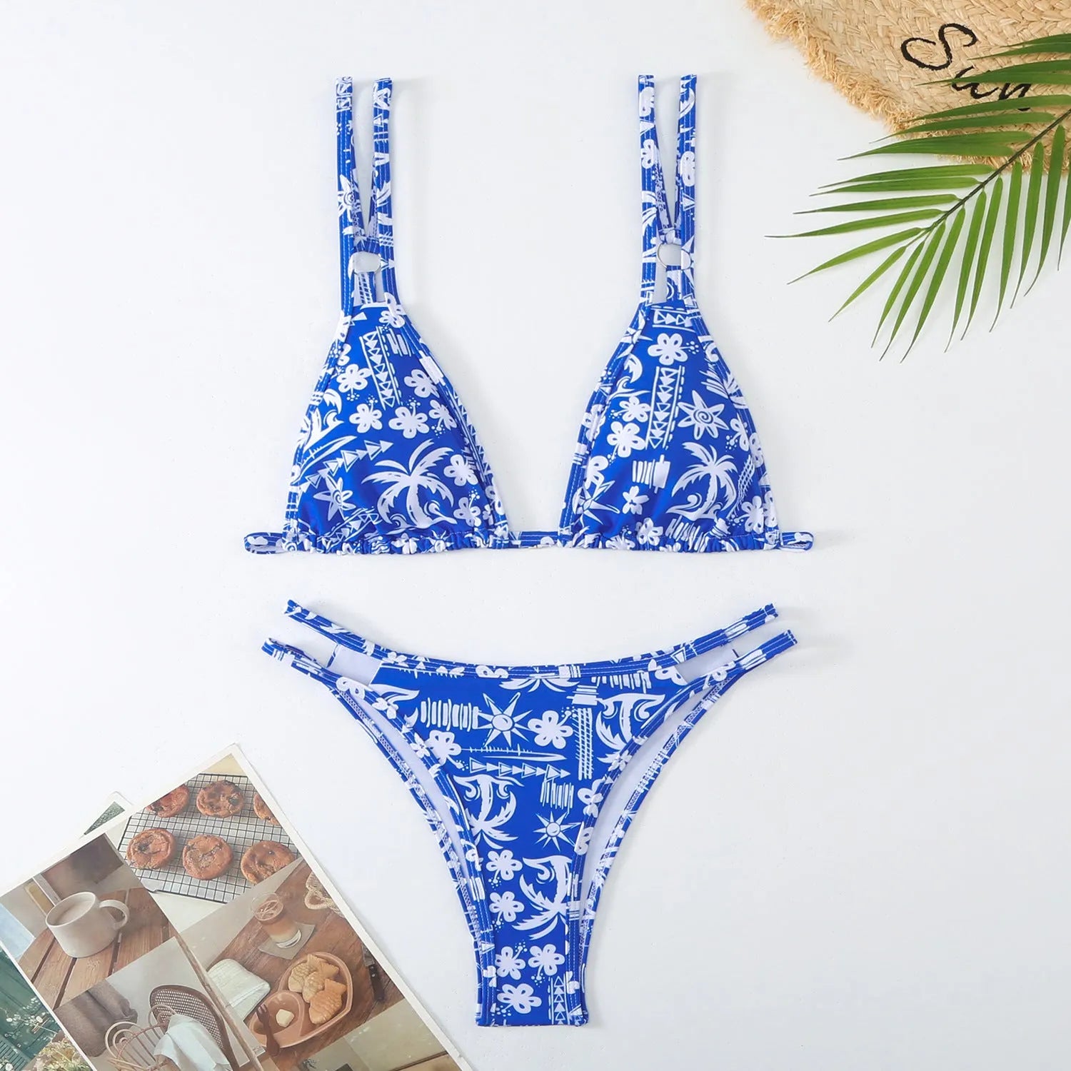Women's blue halter-style swim briefs with a floral pattern, backless design.
