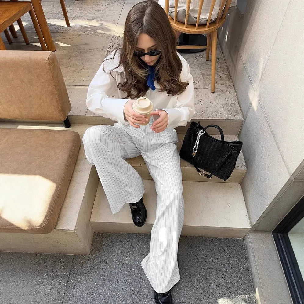 White wide-leg trousers with vertical stripes, loose casual fit, zipper detail, suitable for commuting and office wear