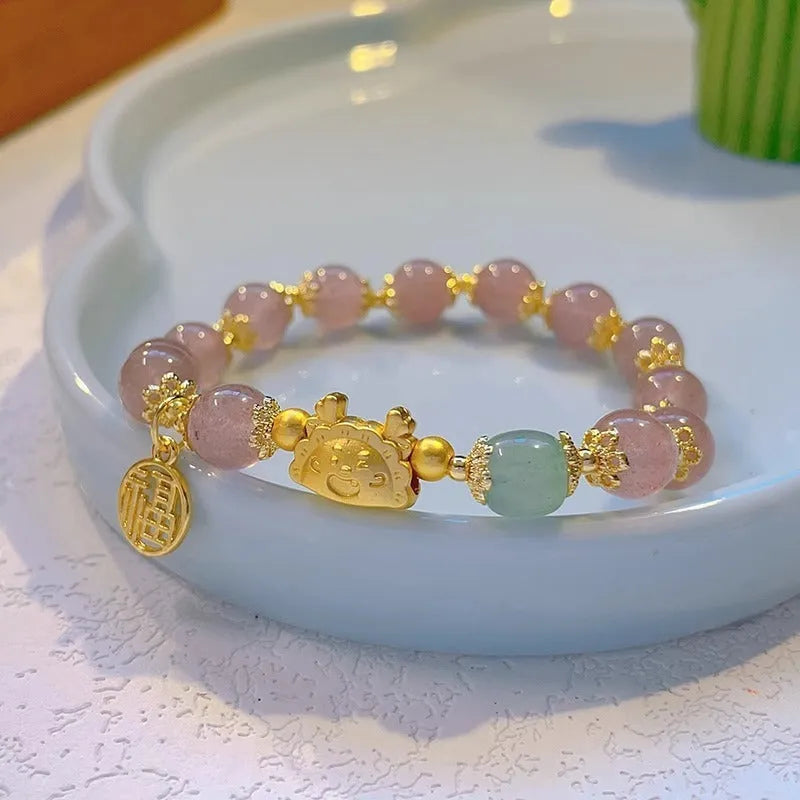 Women's floral glazed bracelet with coloured glass beads and zodiac animal charm on electroplated metal.