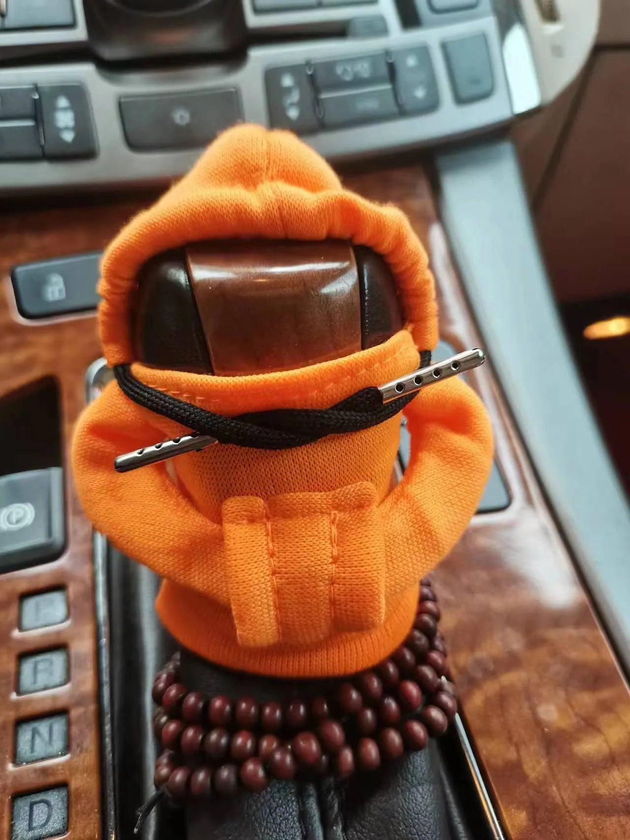 Soft Dutch velvet car gear handle cover in multiple colours on a gear stick.