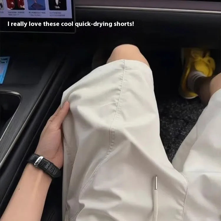 Men's beige quick-drying polyester sports shorts with a straight leg and elastic waistband.