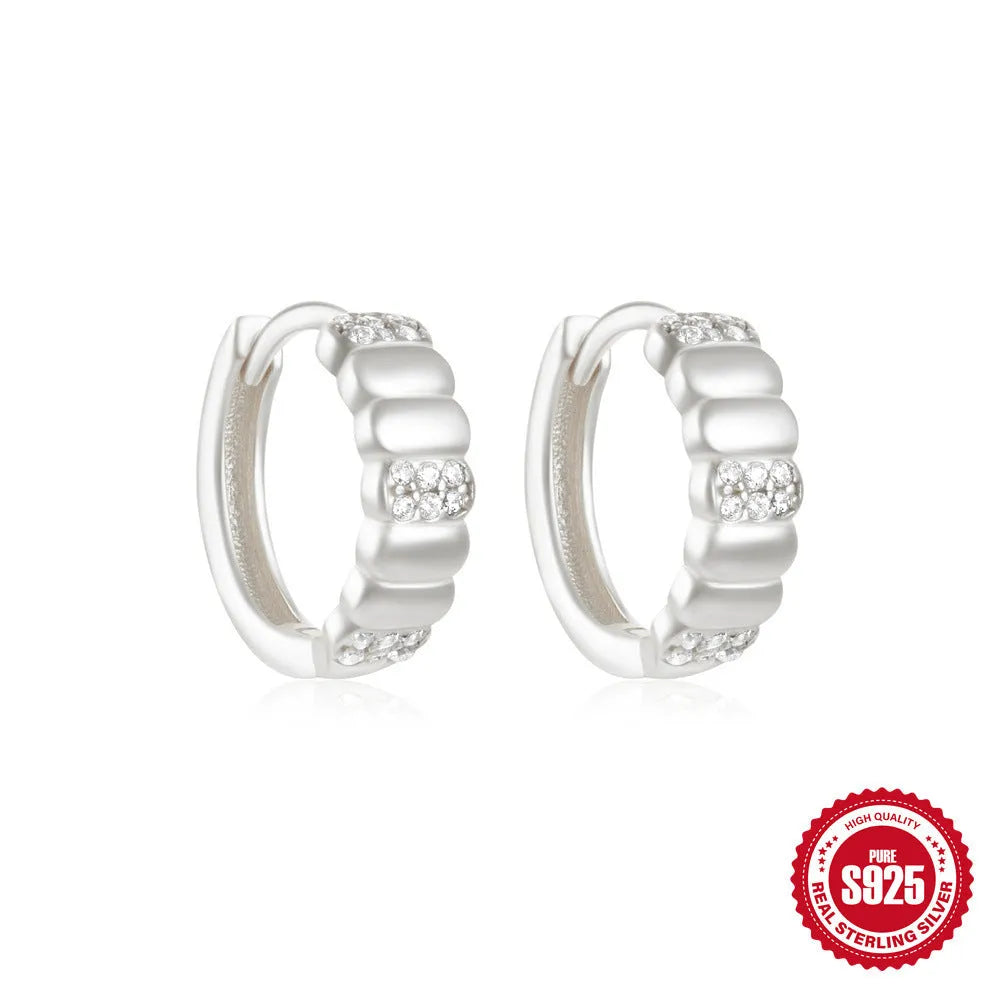 Sterling silver geometric stud earrings with small round diamond detailing in gold and silver electroplated finishes
