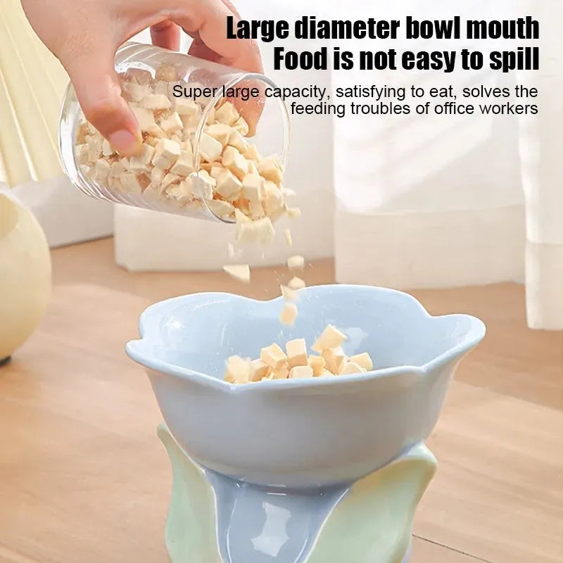 Blue ceramic elevated pet bowl with floral pattern for cats and small dogs on a non-slip base.