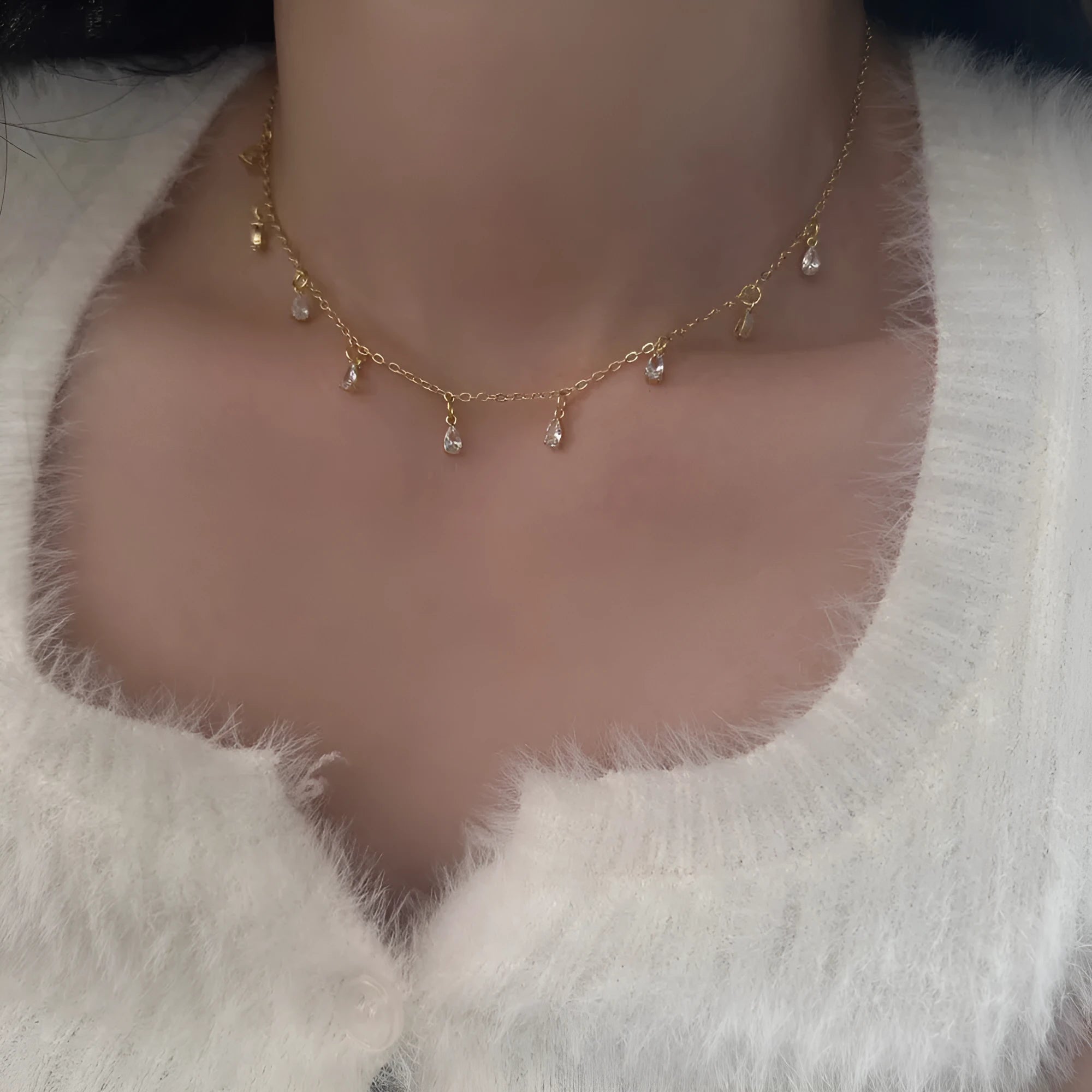 Women's zircon jewellery set with geometric meteor shower necklace, matching earrings, and anklet.