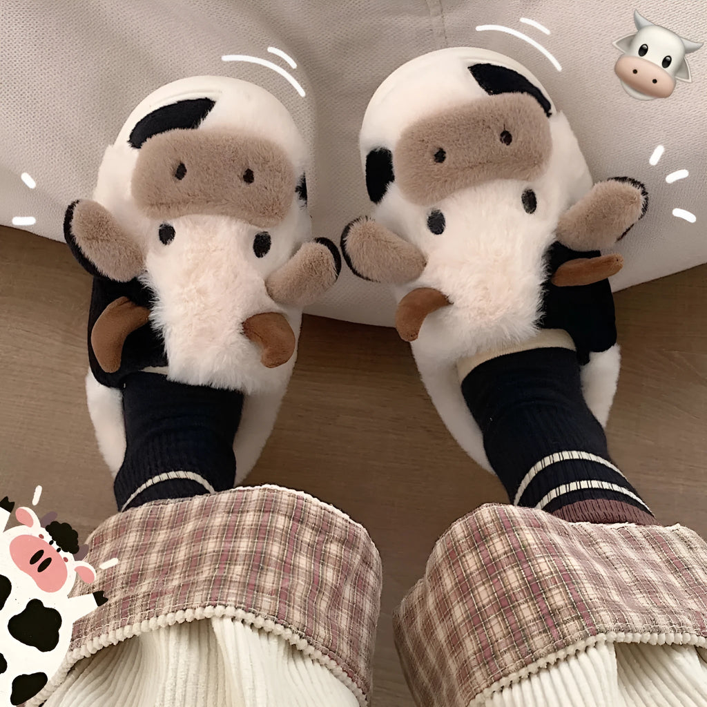 White cow plush slippers with non-slip textured soles shown from above