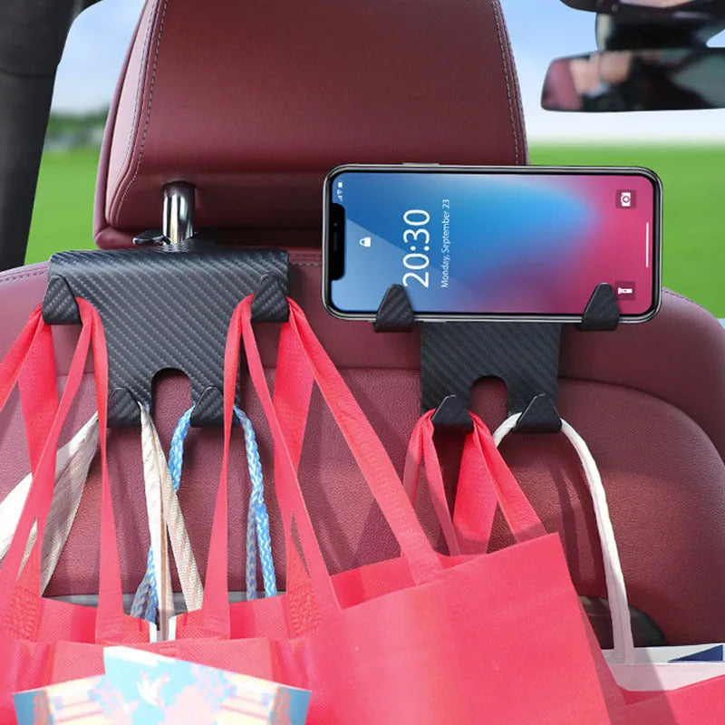 Black ABS plastic car hook and phone holder bracket mounted behind a car seat headrest.