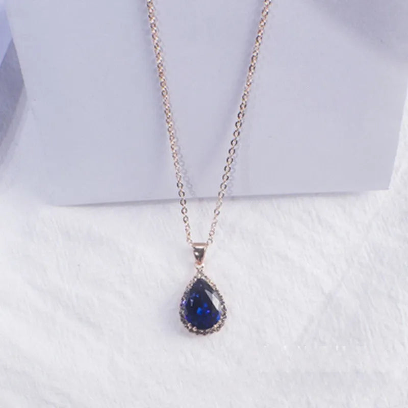 Pink water drop geometric necklace with rose gold electroplating and rhinestone detailing on alloy pendant