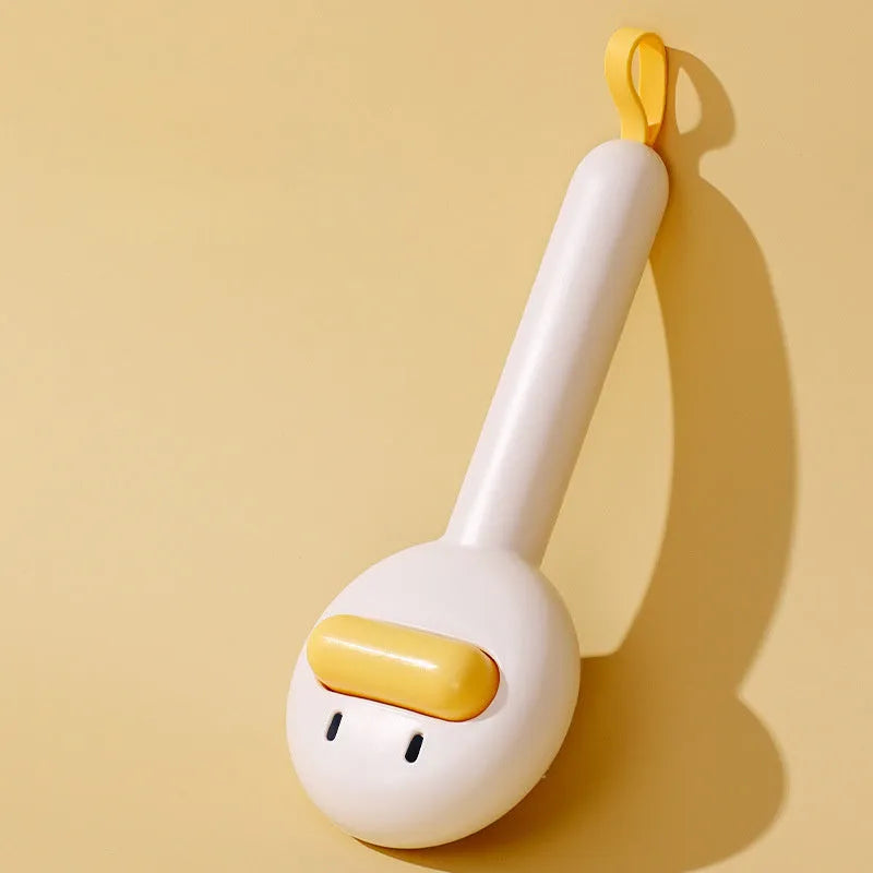 Small yellow duck-shaped pet grooming comb with open section and floating needles