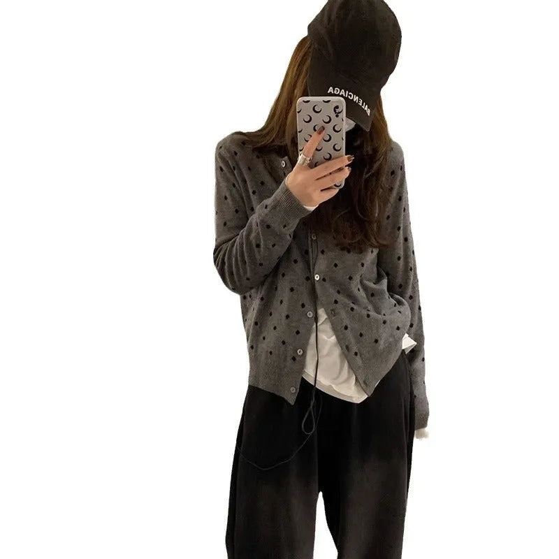 Women's grey dot pattern knitted cardigan with crocheted flower detail and long sleeves