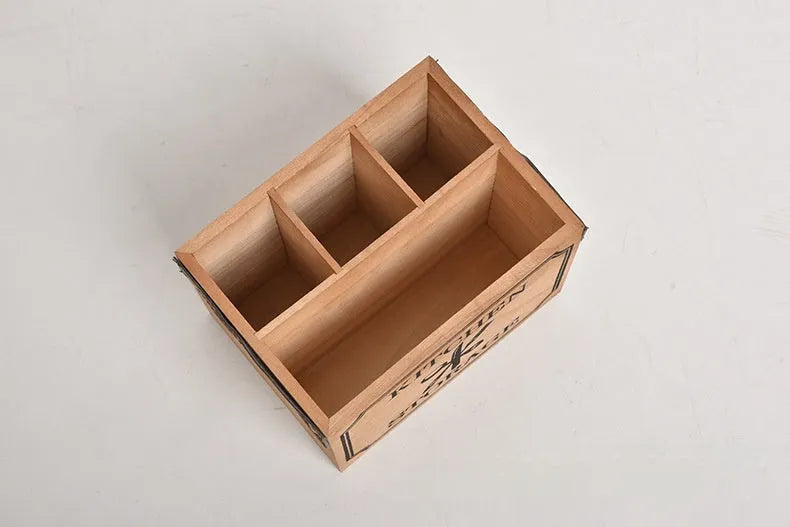 Natural wooden kitchen storage box with internal grid dividers for organising knives, forks, and chopsticks.
