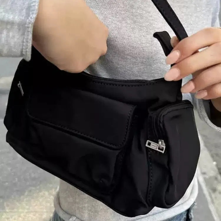 Simple black lightweight PU women's shoulder bag with double pockets and side line detail.