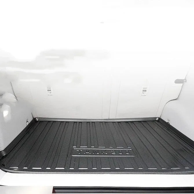 Black TPE car boot liner with carbon fibre pattern texture.