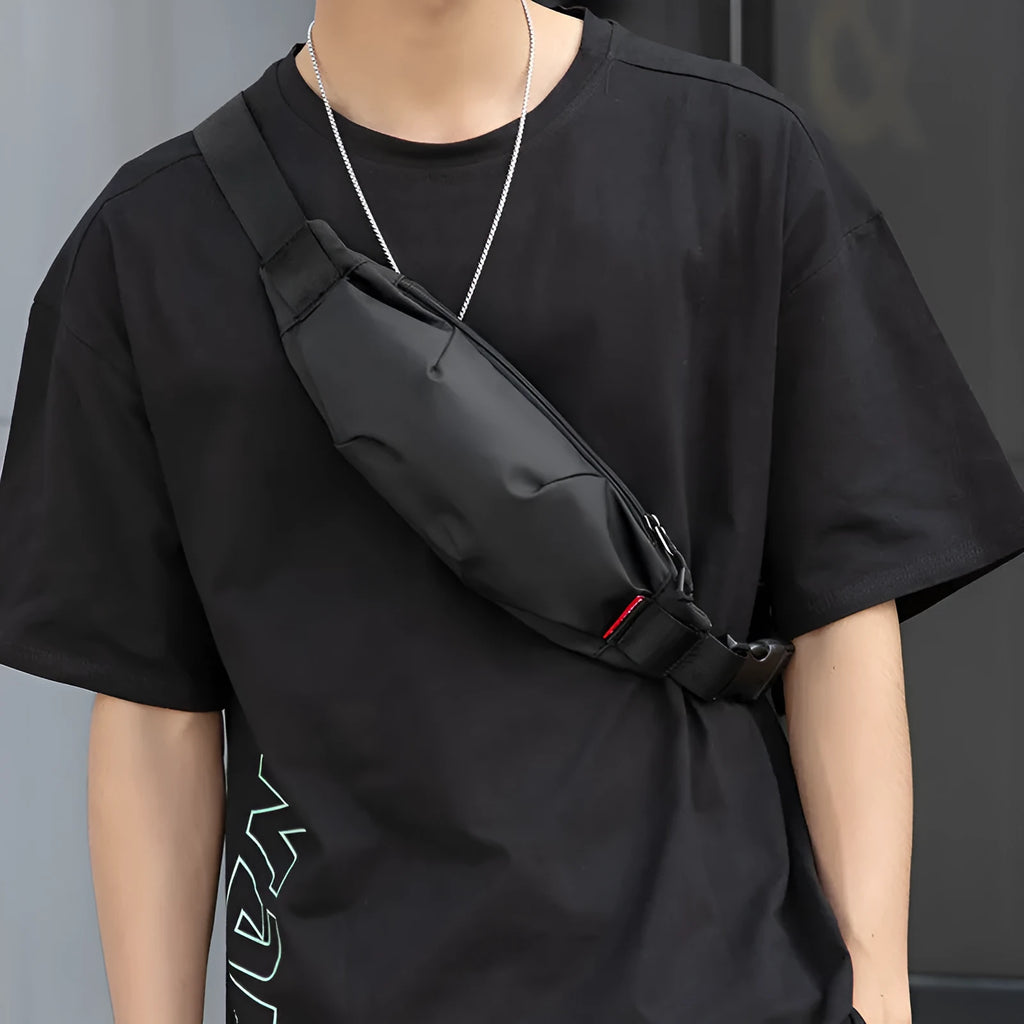 Black oxford cloth men's waist pack showing zipper opening and internal organisation pockets.