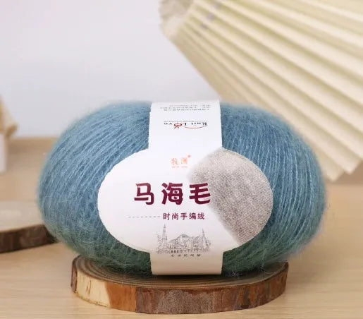 Single ball of mohair yarn in various colours for hand-woven DIY scarf knitting projects