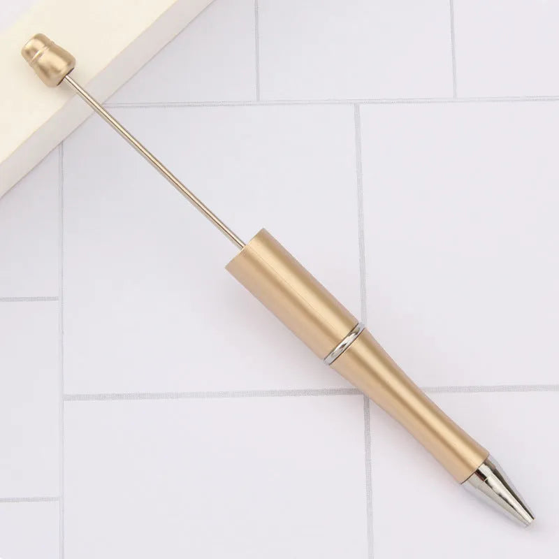 Creative ballpoint pen with multicoloured spinning plastic beads on a steel wire frame.