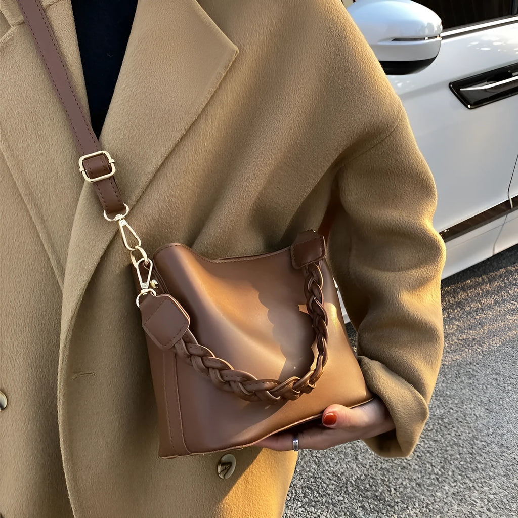 Retro khaki crossbody bucket bag with woven PU detailing and adjustable strap.