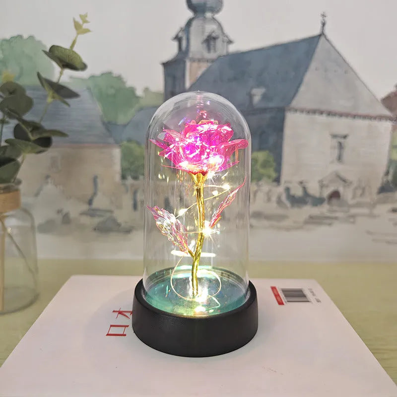 Small plastic night lamp with floral decoration and coloured light options on a black base.