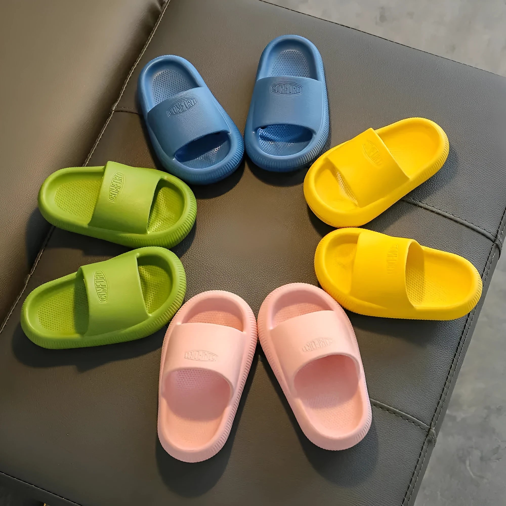 Children's non-slip EVA slippers in bright colours, showing the 1.5cm thick sole.