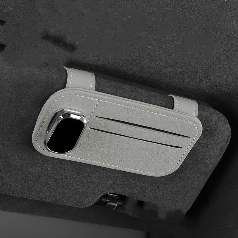 Beige leather car sun visor card holder with a glasses clip shown installed on a vehicle visor.