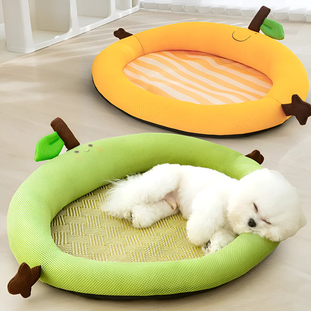 Green pet cooling mat with a raised fruit-shaped backrest, shown with a dog resting on it.